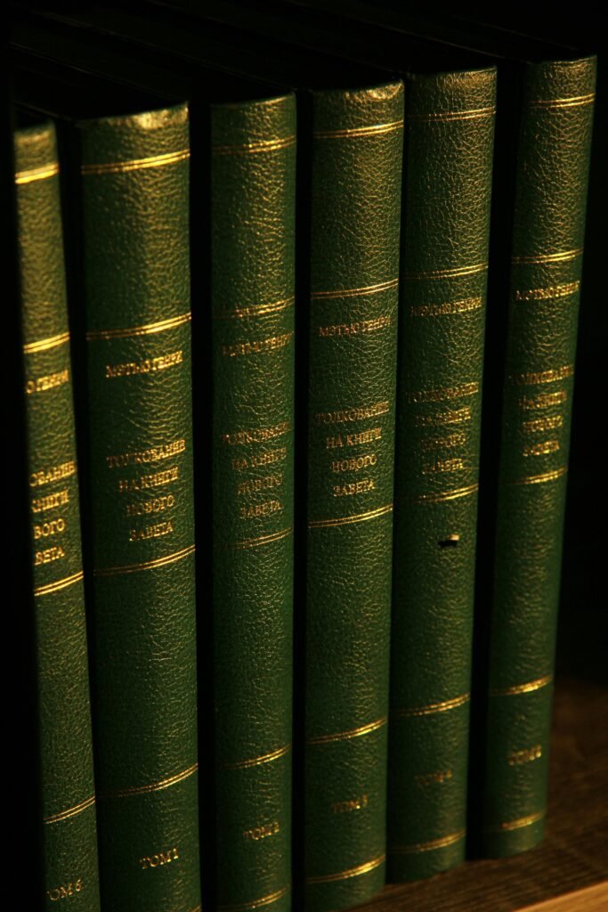 Vertical shot of elegant green leather-bound books in soft light, perfect for literature themes.